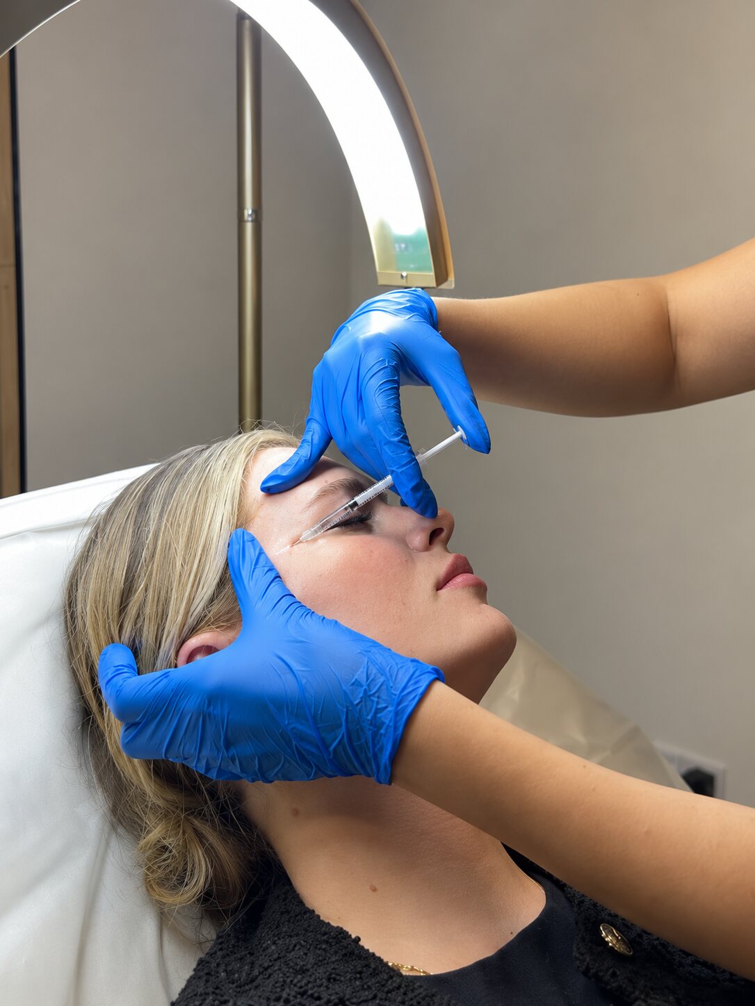 Practitioner performing an injectable skin treatment on a client in the clinic